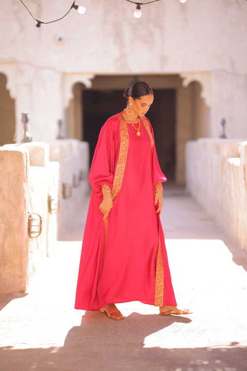 Woman in a Deep Pink Abaya standing outdoor 