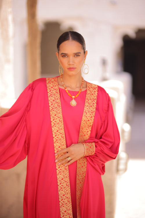 Woman in a Deep Pink Abaya standing outdoor 