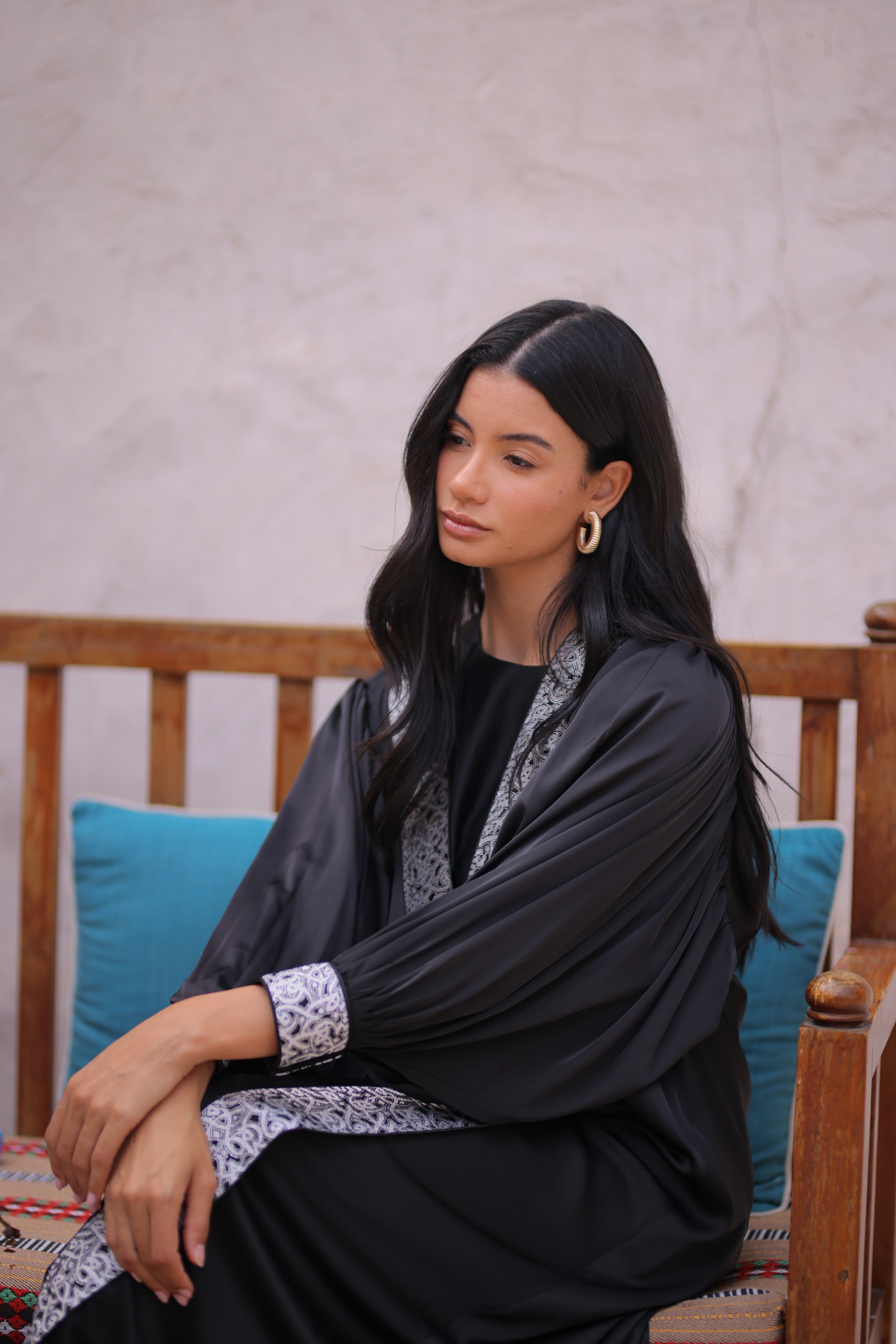 Woman wearing a black dress with silver trim